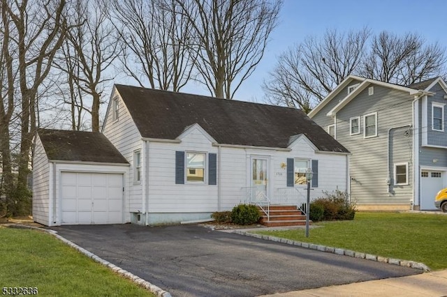 view of front of house with a front yard and a garage