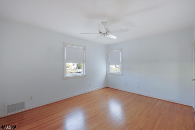 empty room with light wood-type flooring and ceiling fan