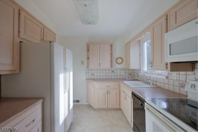 kitchen with white appliances, decorative backsplash, sink, and light brown cabinets