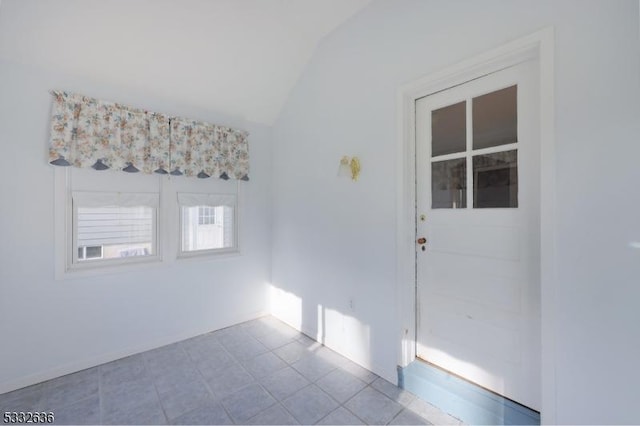 unfurnished room with vaulted ceiling