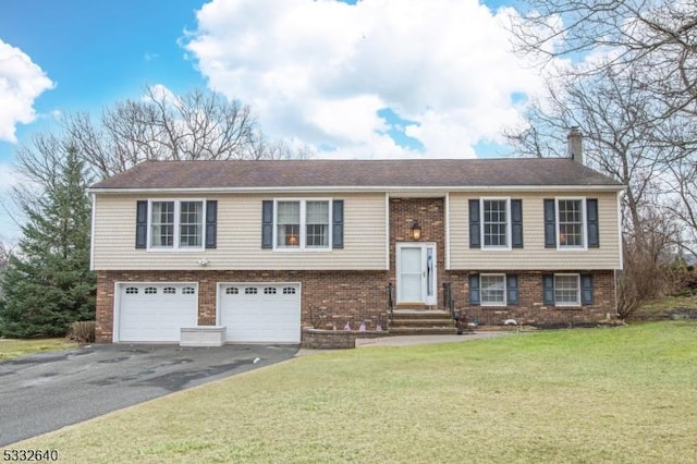 raised ranch with a front yard and a garage