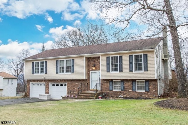 raised ranch featuring a garage and a front yard