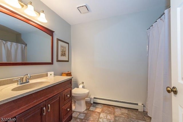 bathroom featuring vanity, toilet, and baseboard heating