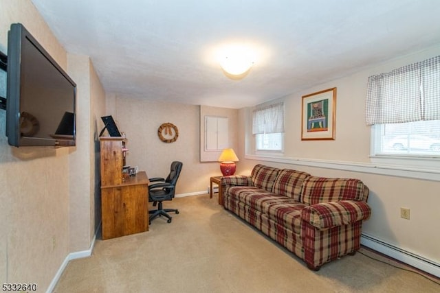 carpeted office space featuring baseboard heating and a healthy amount of sunlight