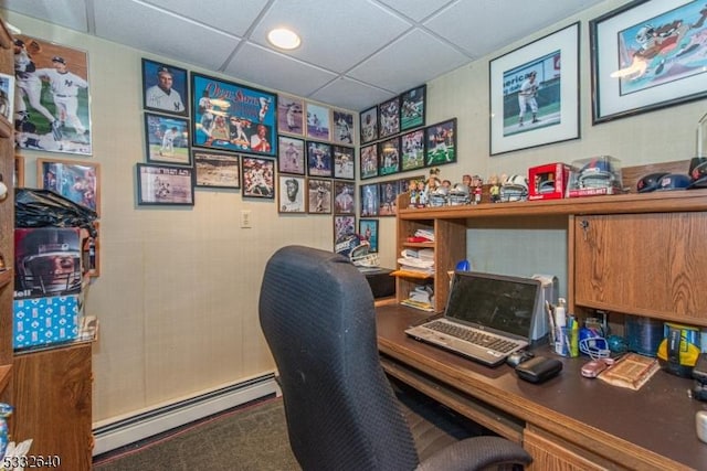 office area featuring a drop ceiling, carpet floors, and a baseboard heating unit