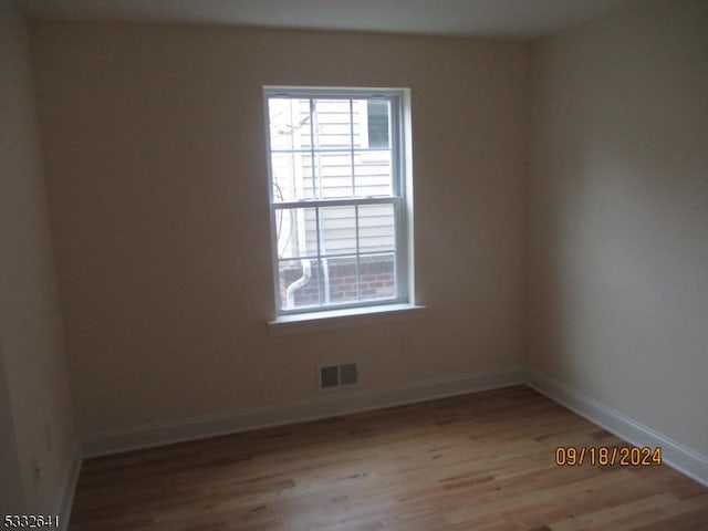 unfurnished room with light hardwood / wood-style floors