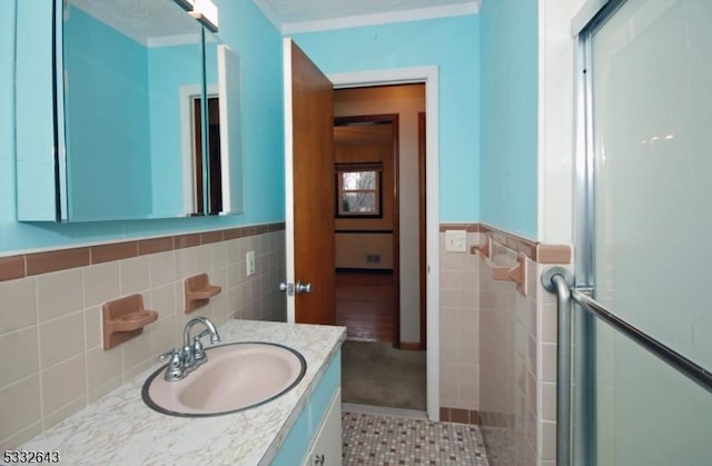 bathroom featuring tile patterned floors, vanity, and tile walls