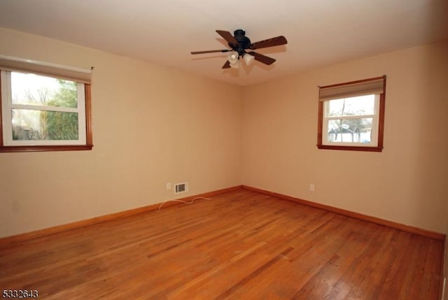 unfurnished room with hardwood / wood-style flooring and ceiling fan