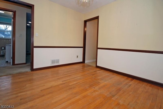 spare room featuring light hardwood / wood-style floors