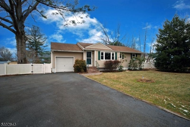 single story home with a garage and a front lawn