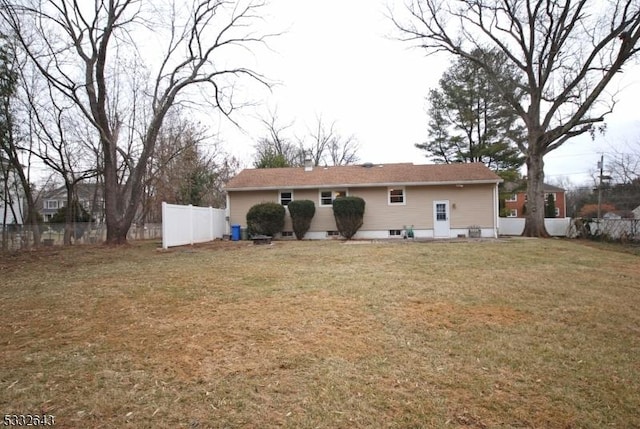 back of property with a lawn