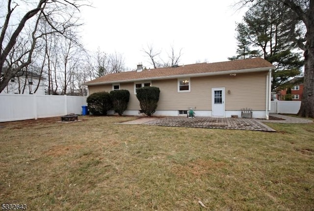 back of house with a patio and a lawn