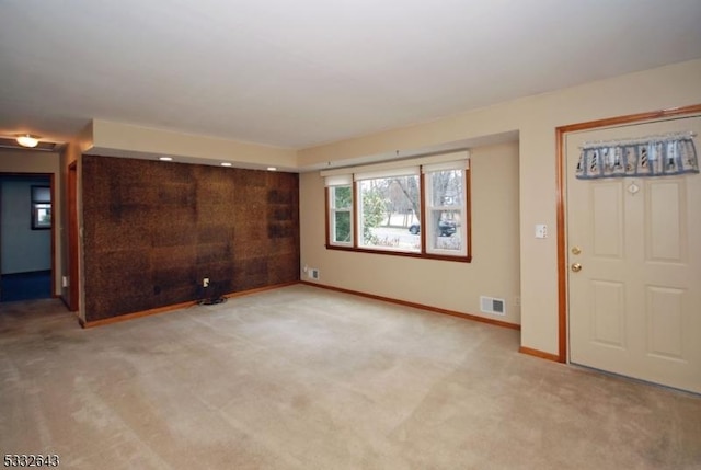 unfurnished living room featuring light carpet