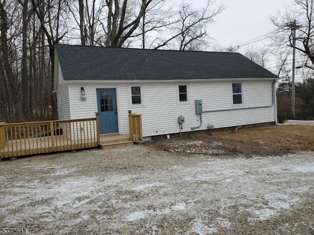 rear view of property featuring a deck