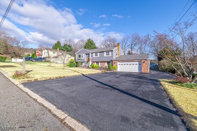 view of front of property with a front lawn and a garage