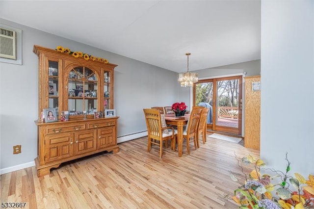 dining space with a baseboard radiator, an inviting chandelier, light wood-type flooring, and a wall mounted air conditioner