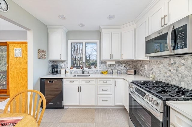 kitchen featuring sink, white cabinetry, and appliances with stainless steel finishes