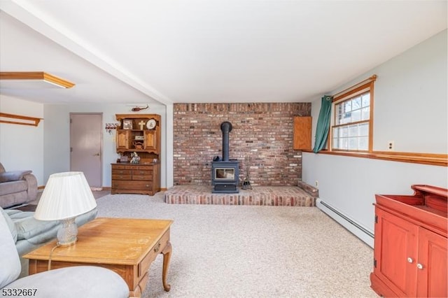 carpeted living room with baseboard heating and a wood stove