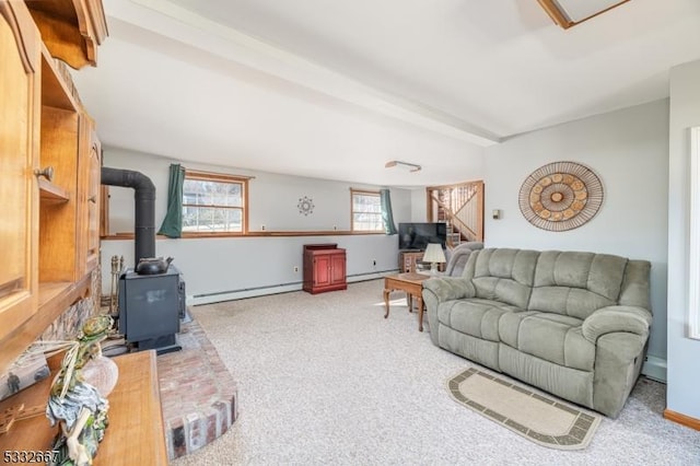 carpeted living room featuring a baseboard heating unit, a wood stove, and beamed ceiling