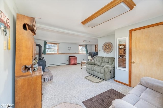 living room with a baseboard radiator, a wood stove, and light colored carpet