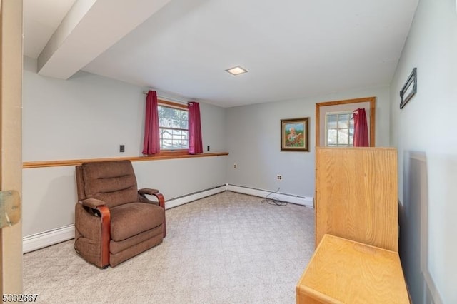 living area with baseboard heating and light colored carpet