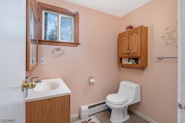 bathroom featuring toilet, a baseboard heating unit, tile patterned floors, and vanity