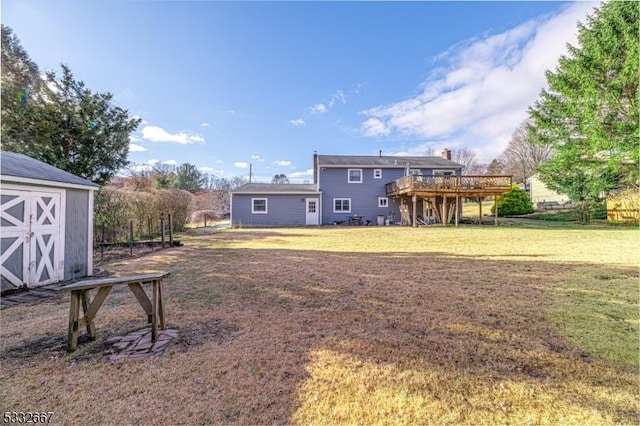 view of yard with a wooden deck and a storage shed