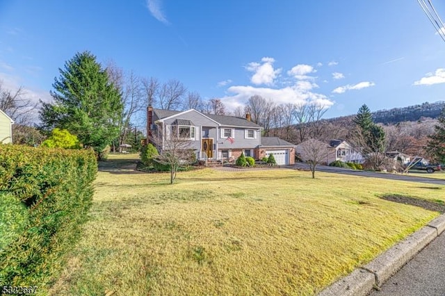 view of front of house with a garage and a front lawn