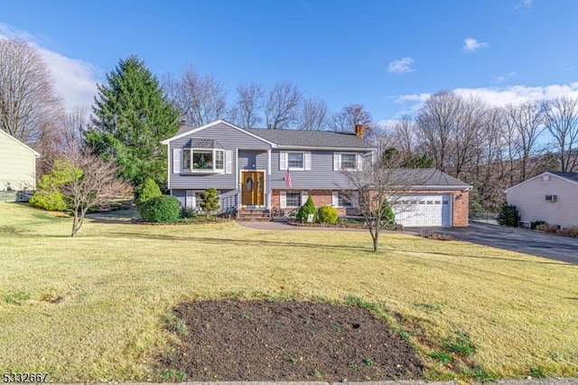 split foyer home featuring a front yard and a garage