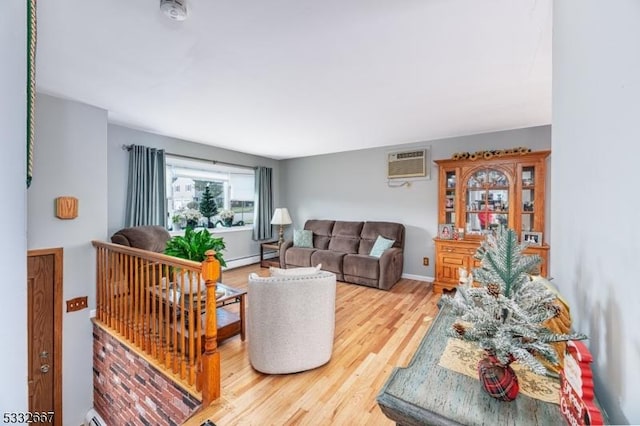 living room with an AC wall unit, baseboard heating, and hardwood / wood-style flooring