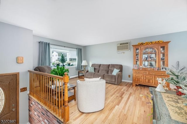 living room with light hardwood / wood-style floors, a wall mounted AC, and a baseboard heating unit