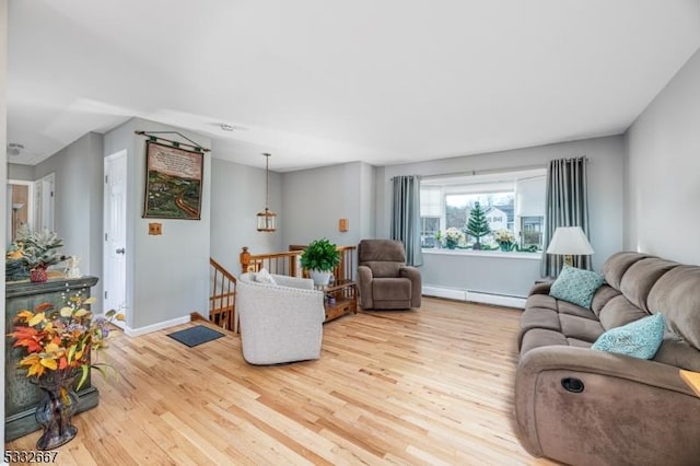 living room featuring light wood-type flooring and a baseboard radiator