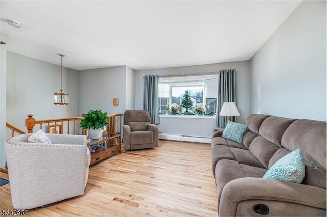 living room with light hardwood / wood-style flooring and a baseboard heating unit