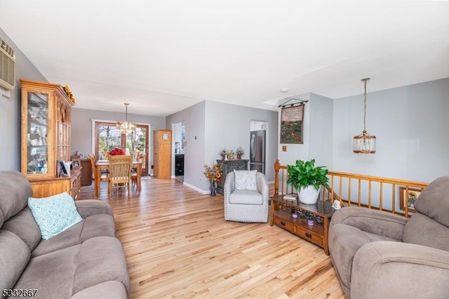 living room with light wood-type flooring and a notable chandelier