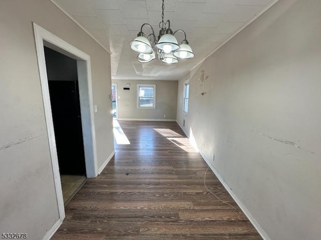 unfurnished dining area with dark hardwood / wood-style floors and a notable chandelier