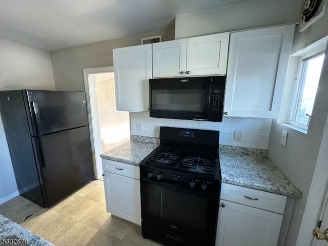 kitchen featuring tasteful backsplash, white cabinetry, and black appliances