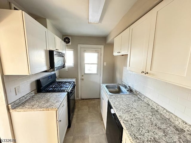 kitchen with backsplash, sink, white cabinets, and black appliances