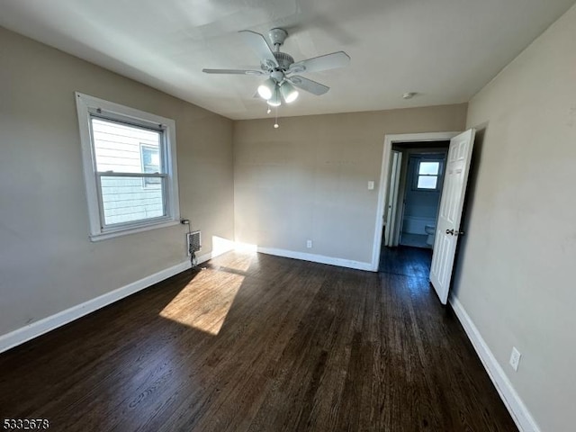 spare room with ceiling fan and dark wood-type flooring