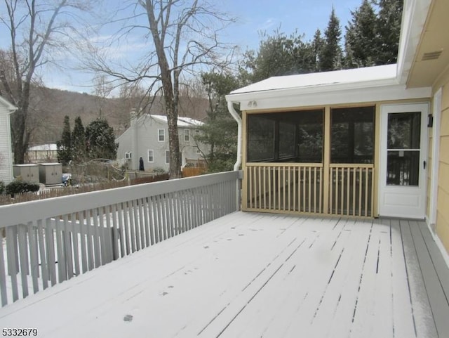 deck featuring a mountain view and a sunroom