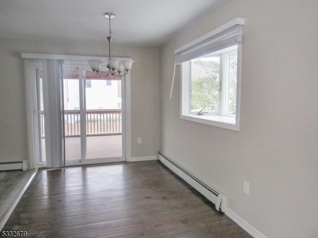 unfurnished dining area featuring dark hardwood / wood-style floors, a baseboard heating unit, and a notable chandelier