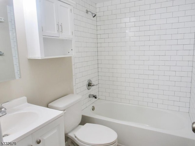 full bathroom featuring vanity, toilet, and tiled shower / bath