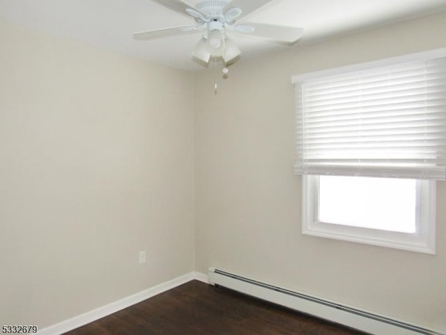 unfurnished room with ceiling fan, dark wood-type flooring, and a baseboard heating unit