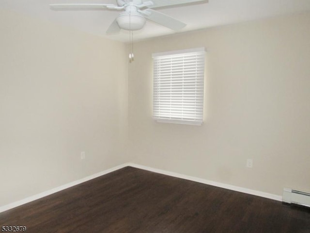 spare room featuring ceiling fan, a baseboard radiator, and dark hardwood / wood-style floors