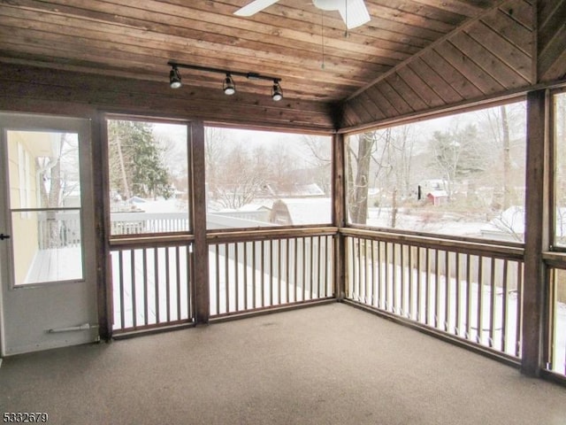 unfurnished sunroom with ceiling fan and wooden ceiling