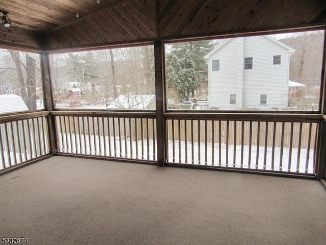 unfurnished sunroom with a wealth of natural light and wooden ceiling