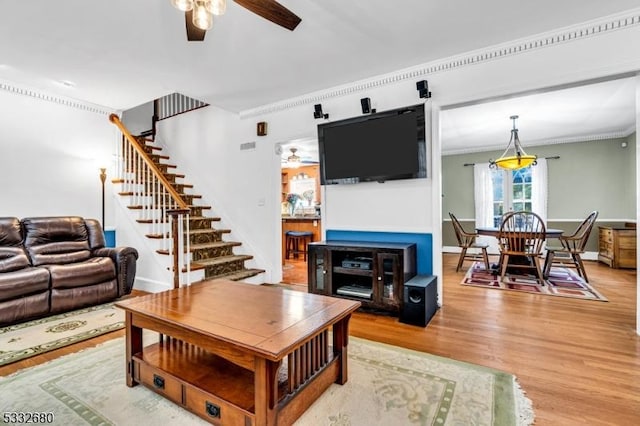 living room featuring ceiling fan, crown molding, and hardwood / wood-style floors