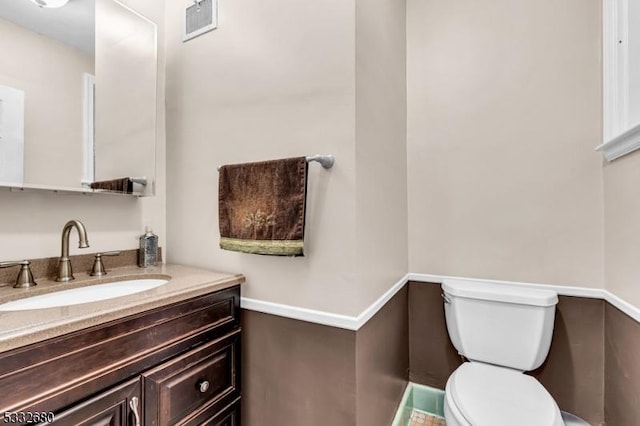 bathroom featuring toilet and vanity