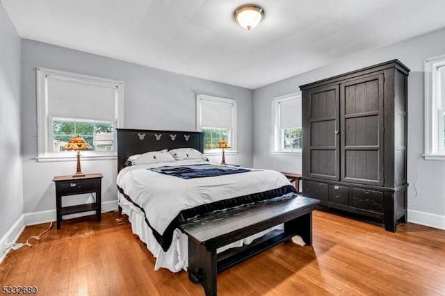 bedroom featuring hardwood / wood-style floors and multiple windows