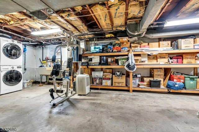 basement featuring stacked washer / dryer