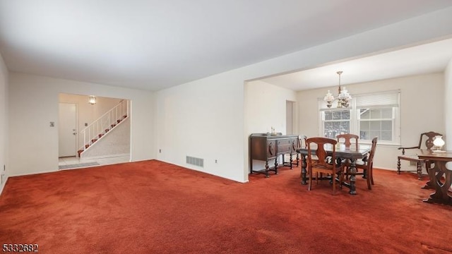 carpeted dining space featuring a chandelier